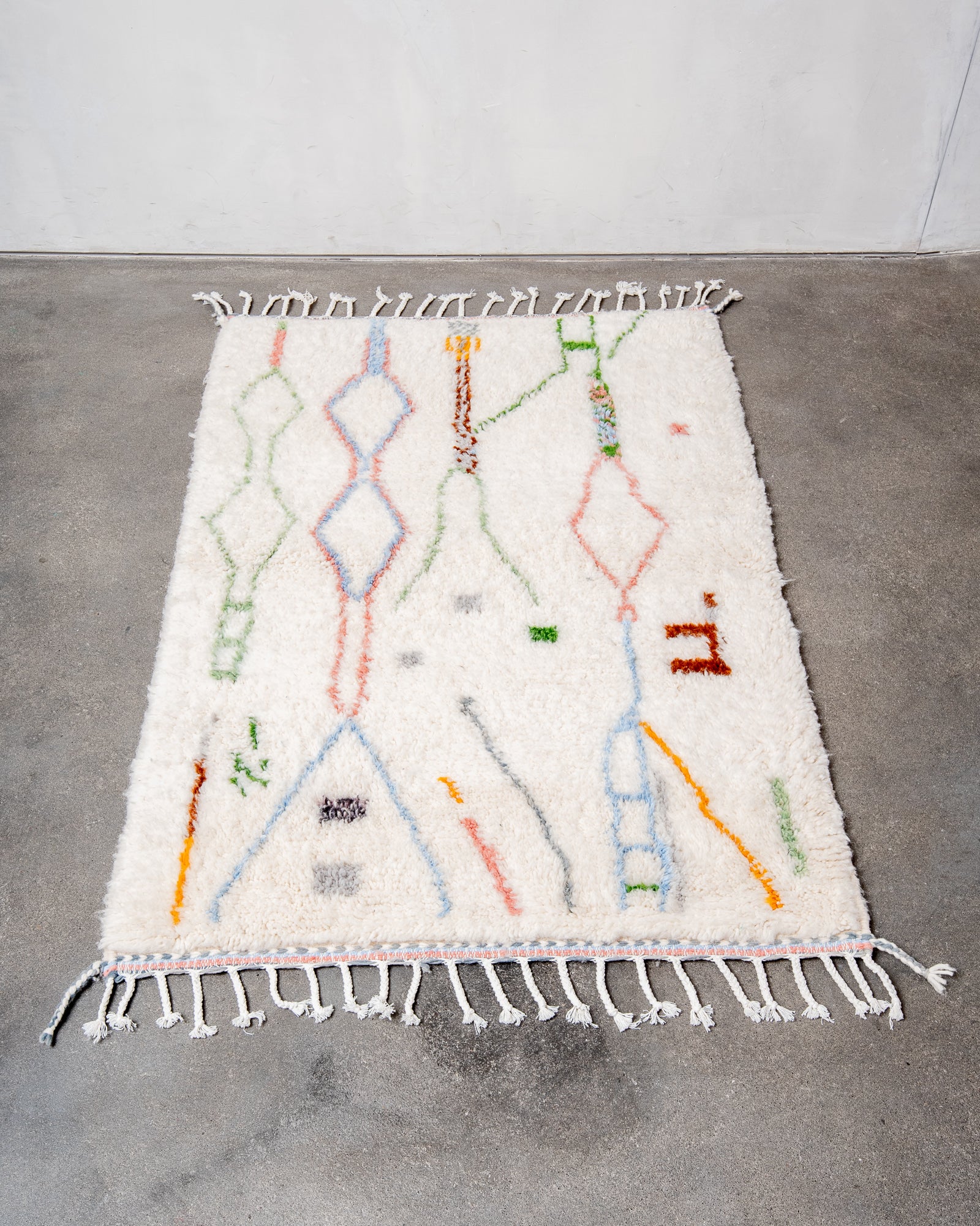 Modern, designer, handcrafted Berber rug from Morocco. Beniourain carpet with beautiful colours and patterns and fluffy wool texture.